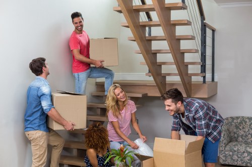 Professional movers carrying furniture on a Clapham street
