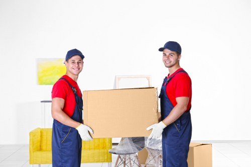 Local movers handling furniture in a Clapham residential street